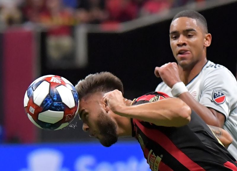 Atlanta United forward Hector Villalba (15) heads the ball over New England Revolution midfielder Brandon Bye (15) in the second half during the first round of the MLS playoffs at Mercedes-Benz Stadium on Saturday, October 19, 2019. Atlanta United won 1-0 over the New England Revolution. (Hyosub Shin / Hyosub.Shin@ajc.com)
