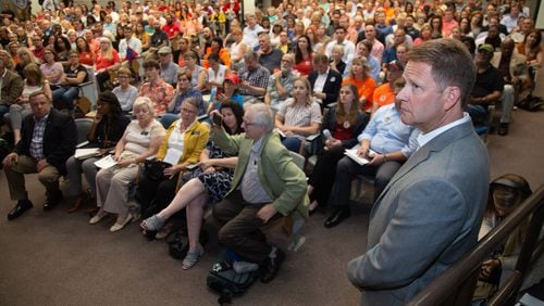 Sterigenics President Philip Macbabb waits his turn to talk to a packed house at the start of a community meeting to address concerns over toxic emissions from the company’s Cobb plant. Tuesday, July 30, 2019. STEVE SCHAEFER / SPECIAL TO THE AJC