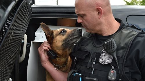 16 Atlanta: Sandy Springs Police Officer Michael DeWald gets a kiss from his K-9 partner, Rock, who was injured earlier this week. Rock is recovering from his injuries suffered from a suspect wearing brass knuckles. BRANT SANDERLIN/BSANDERLIN@AJC.COM
