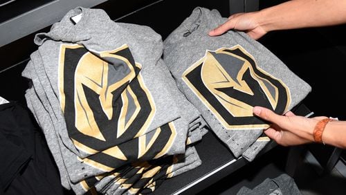 LAS VEGAS, NV - NOVEMBER 22:  T-shirts with the team logo for the Vegas Golden Knights are folded and stacked after being announced as the name for the Las Vegas NHL franchise at T-Mobile Arena on November 22, 2016 in Las Vegas, Nevada. The team will begin play in the 2017-18 season.  (Photo by Ethan Miller/Getty Images)