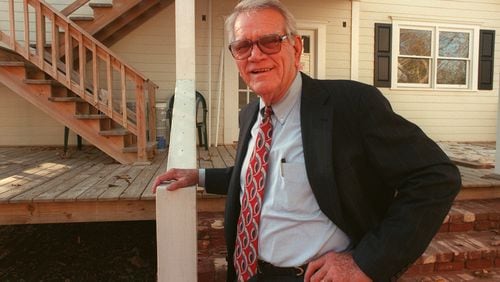 Former Roswell Mayor W.L. "Pug" Mabry died Friday, April 28, 2023, at age 95. In this 1998 photo, he was restoring the 1916 house pictured in the background. (AJC file photo)
