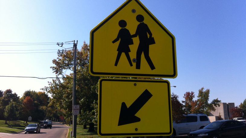 A Milton police officer will work as a crossing guard near Cambridge High School until new pedestrian signals are installed.