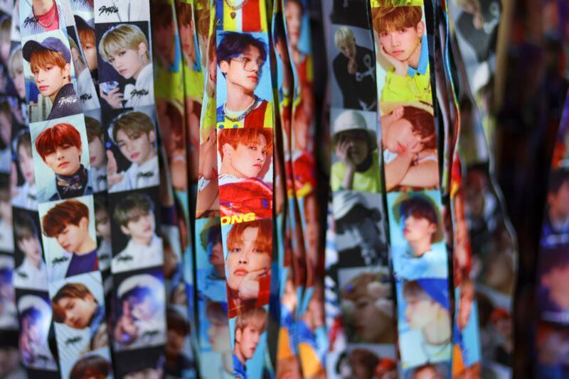 Fans love to collect K-pop merchandise like these neck lanyards at the KPOP Store in USA. (Jason Getz / Jason.Getz@ajc.com)