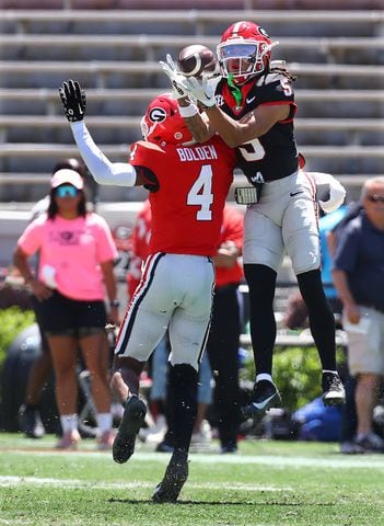 Wide receiver Anthony Evans III goes up for a reception over defensive back KJ Bolden for a long gain during the G-Day game on Saturday, April 13, 2024.  Curtis Compton for the Atlanta Journal Constitution