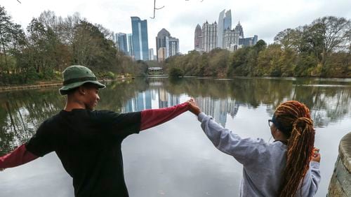Dec. 11, 2015 Atlanta: With above normal, mild December temperatures, Daryle Donaldson, 21 (left) and Afeni Quarles, 20 (right) decided Friday, Dec. 11, 2015 would be an excellent day to take in Lake Clara Meer at Piedmont Park. JOHN SPINK / JSPINK@AJC.COM