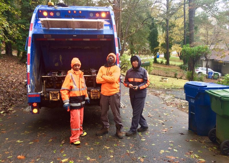 Michael Swift (center), a driver for Atlanta’s solid waste department, on the route with fellow workers Nichole White (left) and Tymeko Mack. 