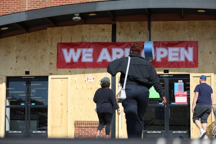 In Atlanta, Ross Store on Edgewood Retail Center shoppers walks in thru protected plywood. Business around town are boarding up windows amid fears of unrest  related to the elections on Tuesday, Nov. 3, 2020, 
Miguel Martinez for The Atlanta Journal-Constitution