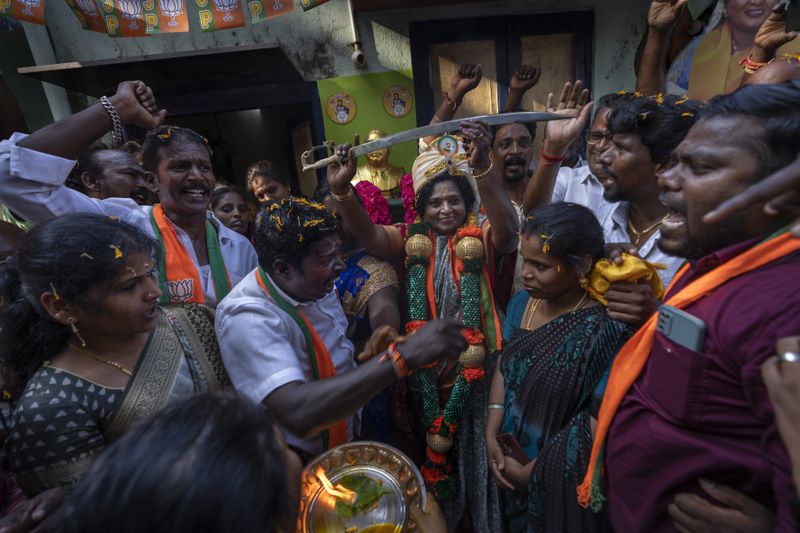 India's ruling Bharatiya Janata Party candidate Tamilisai Soundararajan, center, brandishes a sword during an election campaign rally in Chennai, in the southern Indian state of Tamil Nadu, April 14, 2024. (AP Photo/Altaf Qadri)