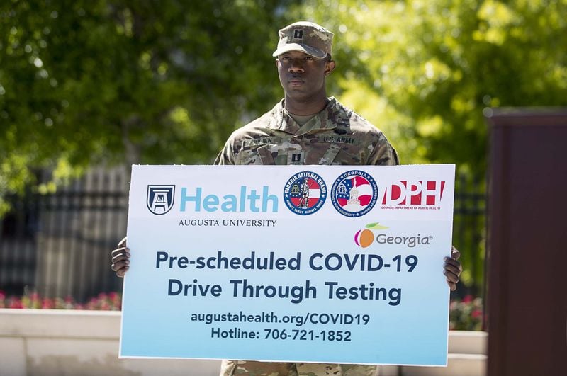 Information regarding a new COVID-19 testing facility in Augusta is displayed during a press conference at Liberty Plaza, across the street from the state Capitol building in Atlanta on Monday, April 20, 2020. (ALYSSA POINTER / Alyssa.Pointer@AJC.com)