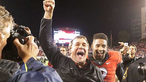 Georgia head coach Kirby Smart and defensive back Maurice Smith, who intercepted a pass and returned it for a touchdown, celebrate a 13-7 victory over Auburn last season in Athens. Curtis Compton/ccompton@ajc.com