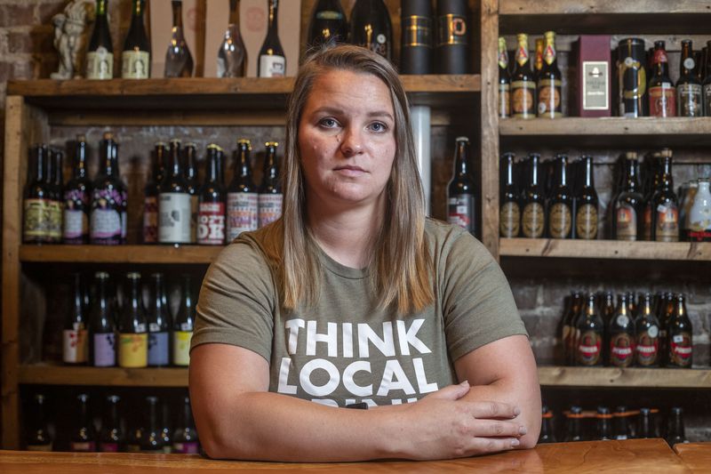 Former New Realm Brewing employee Tracy Bardugon sits for a portrait at The Porter Beer Bar in Atlanta’s Little Five Points community, Monday, June 14, 2021. (Alyssa Pointer / Alyssa.Pointer@ajc.com)