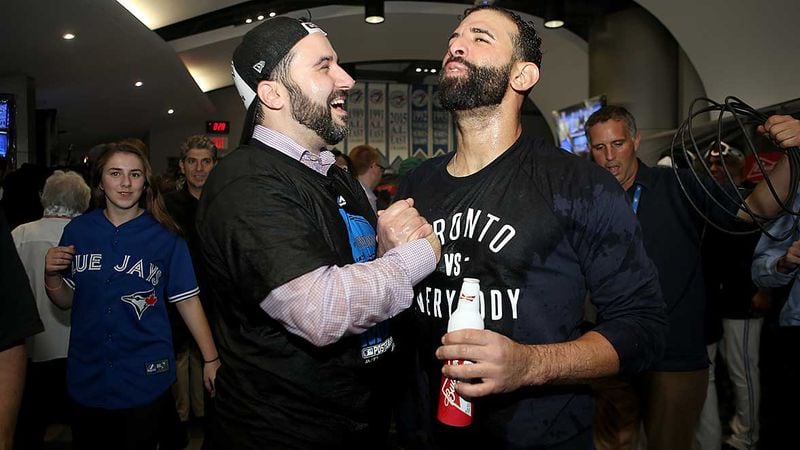 Former Toronto general manager Alex Anthopoulos, now the general manager of the Braves, and outfielder Jose Bautista celebrate Toronto's ALDS win over Texas in 2015. Bautista has agreed to terms on a minor-league contract with the Braves for the 2018 season. (Photo by Tom Szczerbowski/Getty Images)
