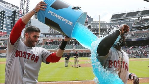 Boston’s Brandon Phillips gets dunked after hitting a 2-run homer to beat the Braves on Wednesday.