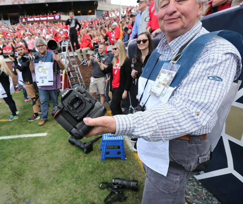 Photographer Perry McIntyre Jr. shows the remains of his camera afer Georgia and Georgia Tech brawled in the end zonen Saturday, Nov. 30, 2019, at Bobby Dodd Stadium in Atlanta.  