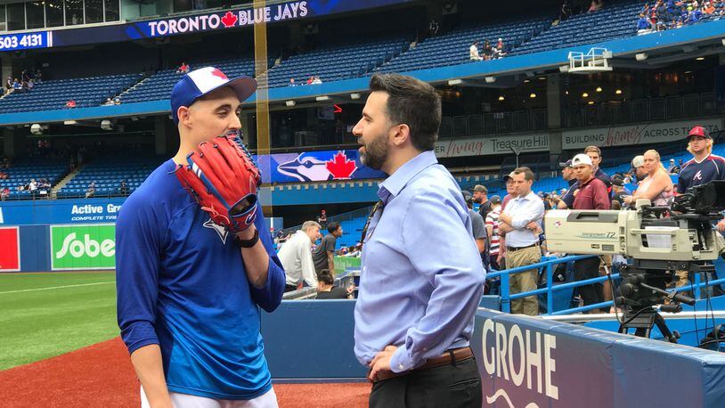Braves general manager Alex Anthopoulos, who once held that post with the Blue Jays, catches up with Toronto pitcher Aaron Sanchez before Wednesday’s game at Rogers Centre. (Photo by David O’Brien/AJC)