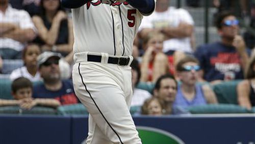 Atlanta Braves' Freddie Freeman hits a two-run home run to score teammate Jason Heyward in the second inning of a baseball game against the Washington Nationals, Sunday, April 13, 2014, in Atlanta. (AP Photo/David Goldman) Freddie Freeman follows through on one of the nine home runs he's hit against the Nationals.
