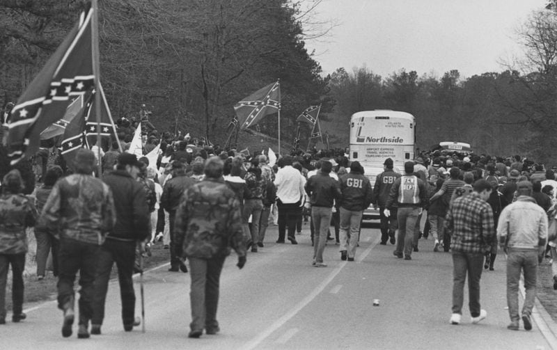 Forsyth County march protesters heckle a bus carrying Atlanta civil rights leaders on January 17, 1987. (Steve Deal, AJC file)
