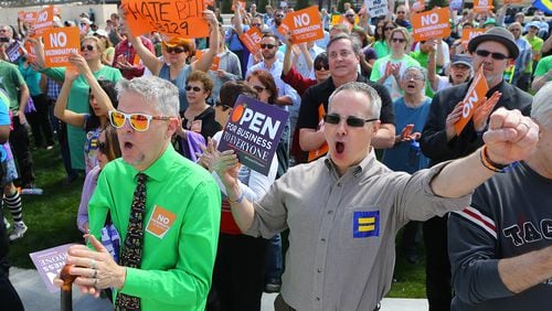 031715 ATLANTA: David Sicay-Perrow (left) and Robert Todd get vocal during a rally at the Capitol against SB 129, the "license to discriminate" legislation pushed by Sen. Josh McKoon and Rep. Sam Teasley on Tuesday, March 17, 2015, at Liberty Plaza in Atlanta. Curtis Compton / ccompton@ajc.com David Sicay-Perrow (left) and Robert Todd get vocal during a rally at the Capitol against S.B. 129, the "religious liberty" legislation pushed by state Sen. Josh McKoon last legislative session. Curtis Compton / ccompton@ajc.com