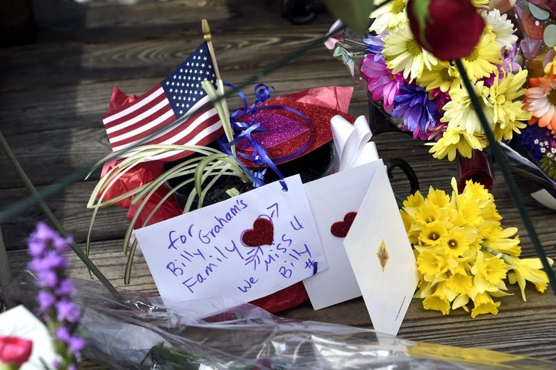 Flowers and notes are left outside Chatlos Chapel in tribute to the Rev. Billy Graham at the Billy Graham Training Center, Thursday, Feb. 22, 2018, in Asheville, NC. (AP Photo/Kathy Kmonicek)