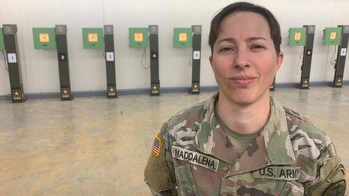 Sgt. Sagen Maddalena stands in front of a row of 10 meter air rifle targets located at a training facility at Fort Moore. Maddalena recently qualified for her second Olympic Games in the 10 meter air rifle event. (Photo Courtesy of Kelby Hutchison)