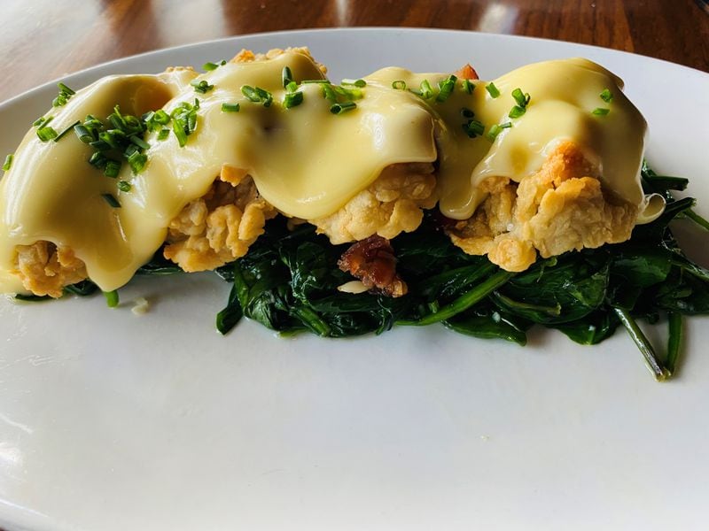 Fried Gulf oysters Rockefeller, with spinach, bacon and hollandaise sauce, are available at Kaiser’s Chophouse. Bob Townsend for The Atlanta Journal-Constitution 