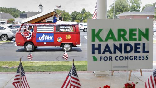A campaign van for Jon Ossoff passes by a sandwich shop in Dunwoody last week, minutes after Karen Handel greeted supporters there. Both are candidates in the Sixth District runoff election. BOB ANDRES /BANDRES@AJC.COM