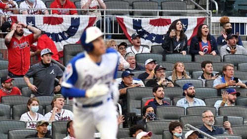 Fans react as Atlanta Braves first baseman Freddie Freeman (5) hits two run home run in the first inning Saturday, April 10, 2021, at Truist Park in Atlanta. (Hyosub Shin / Hyosub.Shin@ajc.com)