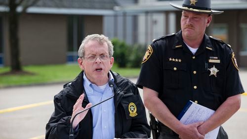 FILE - In this April 27, 2016, file photo, Ohio Attorney General Mike DeWine, left, and Pike County Sheriff Charles Reader, right, discuss the slayings of eight members of the Rhoden family found shot April 22, 2016, at four properties near Piketon, Ohio, during a news conference in Waverly, Ohio. The office of DeWine released redacted autopsy reports Friday, Sept. 23 in the unsolved slayings of the seven adults and a teenage boy, confirming all but one victim was shot multiple times in the head. (AP Photo/John Minchillo, File)