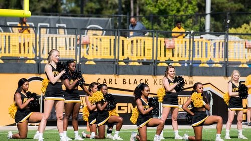 A handful of cheerleaders take a knee during the national anthem prior to the matchup between Kennesaw State and North Greenville, Saturday, Sept. 30, 2017. (Special to AJC/by Cory Hancock)
