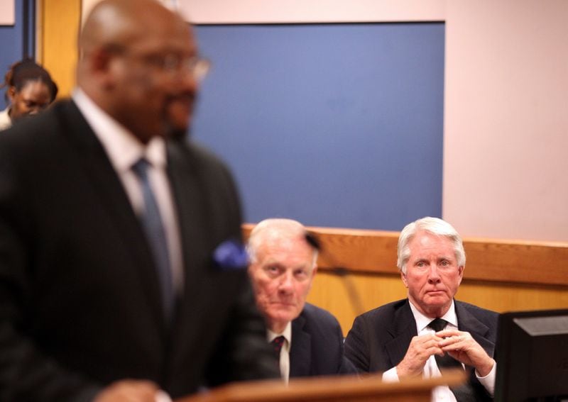 Prosecutor Clint Rucker, foreground, questions a witness during a hearing in April. Defendant Tex McIver, right, looks on. Henry Taylor / henry.taylor@ajc.com