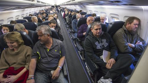 Passengers on a flight in Las Vegas. (Joe Giron/The New York Times)