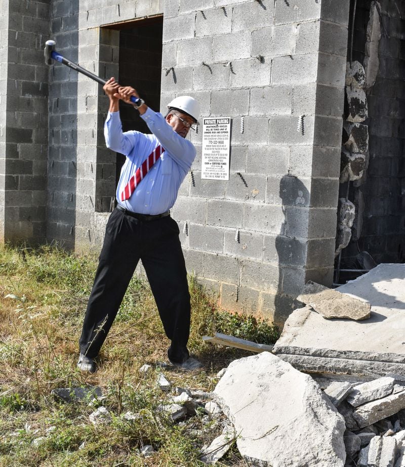 Stonecrest Mayor Jason Lary wields a sledgehammer to begin the demolition of a long-abandoned, half-built hotel near Stonecrest Mall on Wednesday, Oct., 11, 2017. Photo credit: City of Stonecrest