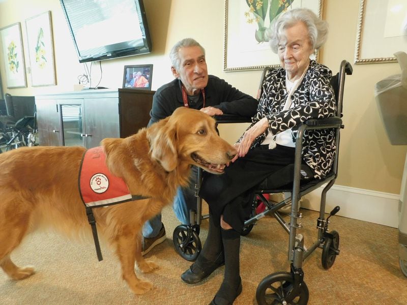 Happy Tails volunteer Howard Shore introduces his veteran therapy dog Leo to Helen Fagan, a resident at Lenbrook senior community. Photo contributed by Lenbrook.