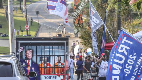 More than 100 protesters gathered outside the Fulton County Jail on Thursday to wait for former President Donald Trump to be booked. (John Spink / John.Spink@ajc.com)