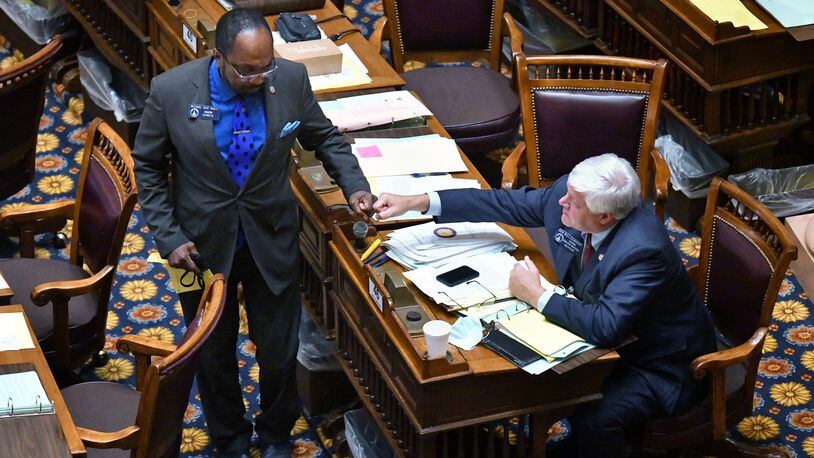 June 23, 2020 Atlanta -  Sen. Michael 'Doc' Rhett (D-Marietta), left, and Sen. Bill Cowsert (R-Athens) give each other a fist bump after Sen. Michael 'Doc' Rhett spoke to support HB-426 in the Senate Chambers on day 37 of the legislative session at Georgia State Capitol on Tuesday, June 23, 2020. HB-426 passed. The bill would implement stiffer penalties if those guilty of crimes are found to have been motivated by hate. (Hyosub Shin / Hyosub.Shin@ajc.com)