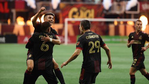 Atlanta United midfielder Thiago Almada celebrates with teammates after scoring the team's first goal during the first half at Mercedes Benz Stadium in an MLS game between Atlanta United and the New Egland Revolution on Sunday, May 15, 2022. Thursday, May 12, 2022. Miguel Martinez / miguel.martinezjimenez@ajc.com