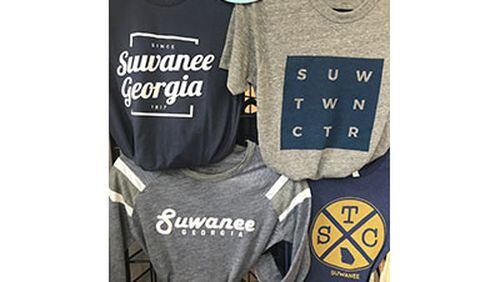 Merchandise like these t-shirts is sold in the Suwanee Welcome Center operated by the North Gwinnett Arts Association in conjunction with the city. Suwanee and the NGAA recently updated how proceeds from sales will be shared. Courtesy City of Suwanee