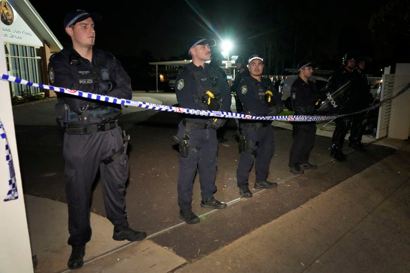 Policemen stand guard outside a church where a bishop and churchgoers were reportedly stabbed in Sydney Australia, Monday, April 15, 2024. Police in Australia say a man has been arrested after a bishop and churchgoers were stabbed in the church. There are no life-threatening injuries. (AP Photo/Mark Baker)