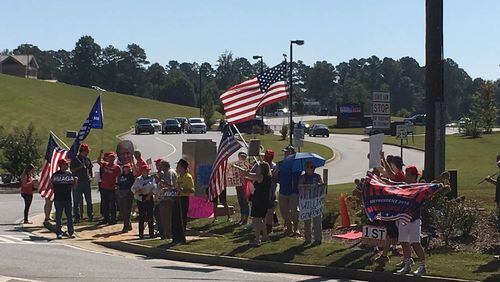 A group of protesters gathered Wednesday near River Ridge High School in Cherokee County. ELLEN ELDRIDGE / ELLEN.ELDRIDGE@AJC.COM