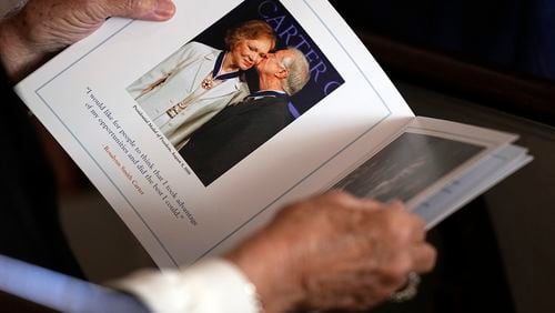 A guest looks at the program before a tribute service for former first lady Rosalynn Carter at Glenn Memorial Church at Emory University on Tuesday, Nov. 28, 2023, in Atlanta. (Brynn Anderson/Pool/AFP/Getty Images/TNS)