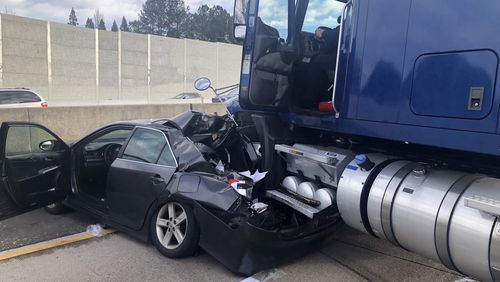 A tractor-trailer collided with a sedan on Ga. 400 in Sandy Springs, closing all southbound lanes. (Credit: Sandy Springs Police Department)