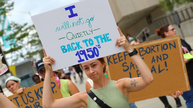 Protesters hold their signs during an abortion rights rally led by members of RiseUp4AbortionRights.org at at CNN Center on Sunday, July 3, 2022, in Atlanta. (Photo: Curtis Compton / Curtis.Compton@ajc.com)
