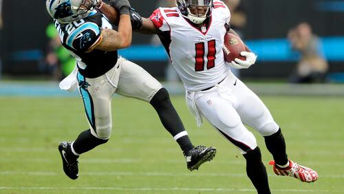 Atlanta Falcons' Julio Jones (11) pushes away Carolina Panthers' Kurt Coleman (20) after a catch in the second half of an NFL football game in Charlotte, N.C., Saturday, Dec. 24, 2016. (AP Photo/Mike McCarn)