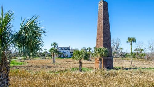 One mile south of Darien on U.S. Highway 17 sits Butler Island, the former site of a large rice plantation. A tall brick chimney, the remains of a steam-powered rice mill, is one of two surviving structures from the original plantation. Over a two-day period in 1859, 436 people enslaved at Butler Island Plantation were sold at auction in Savannah, an event referred to as the Weeping Time. The white house on the current property was built in the mid-1920s by former owner Col. T.L. Huston. Today the Georgia Department of Natural Resources manages the grounds. The Huston House, which is not inhabited nor maintained, was placed on the Georgia Trust for Historic Preservation’s “Places in Peril” list in 2019. COURTESY OF THE COLLECTIVE & CO