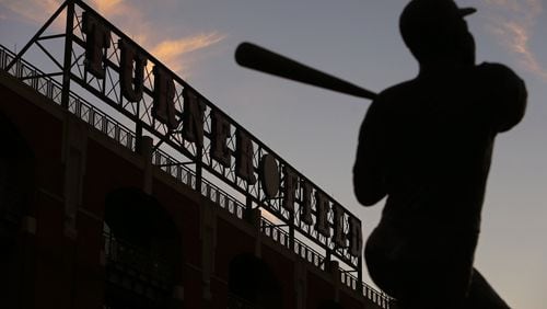 SUNSET ON THE TED--November 11, 2013 Atlanta: The sun sets over Turner Field and a statue of Hank Aaron on Monday evening November 11, 2013, the day the Braves announced that they would be moving to Cobb County. BEN GRAY / BGRAY@AJC.COM