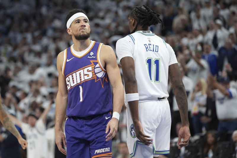 Phoenix Suns guard Devin Booker (1) stands on the court during the second half of Game 1 of an NBA basketball first-round playoff series against the Minnesota Timberwolves, Saturday, April 20, 2024, in Minneapolis. (AP Photo/Abbie Parr)