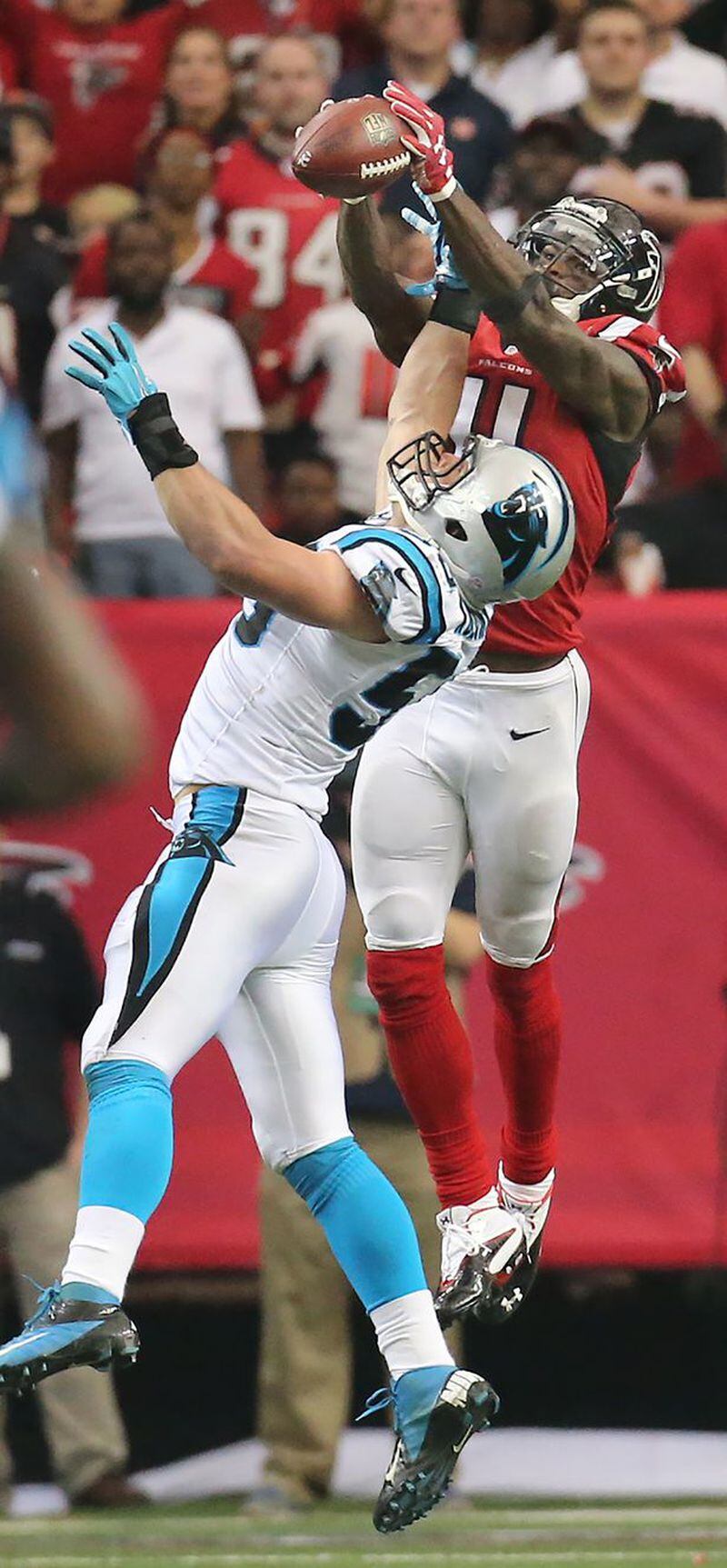 Julio Jones leaps over Carolina Panthers' LB Luke Kuechly for a spectacular catch that resulted in a 70-yard touchdown. (Curtis Compton/ccompton@jc.com)