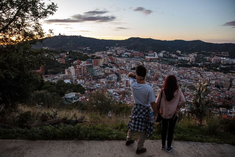 BARCELONA, SPAIN - OCTOBER 22: A couple look on as the sun sets over the city on October 22, 2017 in Barcelona, Spain. The Spanish government is to take steps to suspend Catalonia's autonomy by triggering Article 155 after the Catalan leader Carles Puigdemont threatened to declare independence. Mr Puigdemont has said Catalonia will not accept direct rule by the Spanish government. (Photo by Jack Taylor/Getty Images)