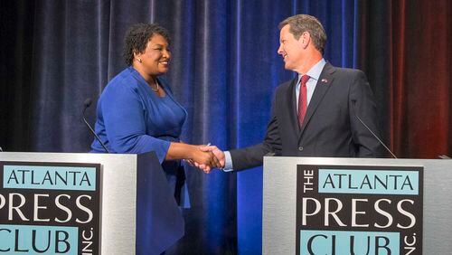 Georgia Democratic nominee for governor Stacey Abrams and Republican nominee  Brian Kemp greet each other before a debate last month.   (ALYSSA POINTER/ALYSSA.POINTER@AJC.COM)
