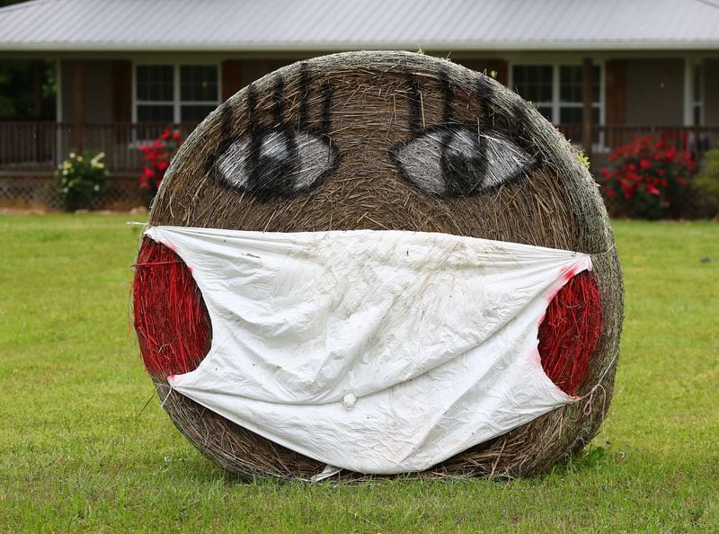 April 22, 2020 Monticello: A resident on Hwy 83 appears to be maintaining a sense of humor decorating a roll of hay with a mask reflecting living in the times of coronavirus on Hwy 83 on Wednesday, April 22, 2020, in Monticello   Curtis Compton ccompton@ajc.com